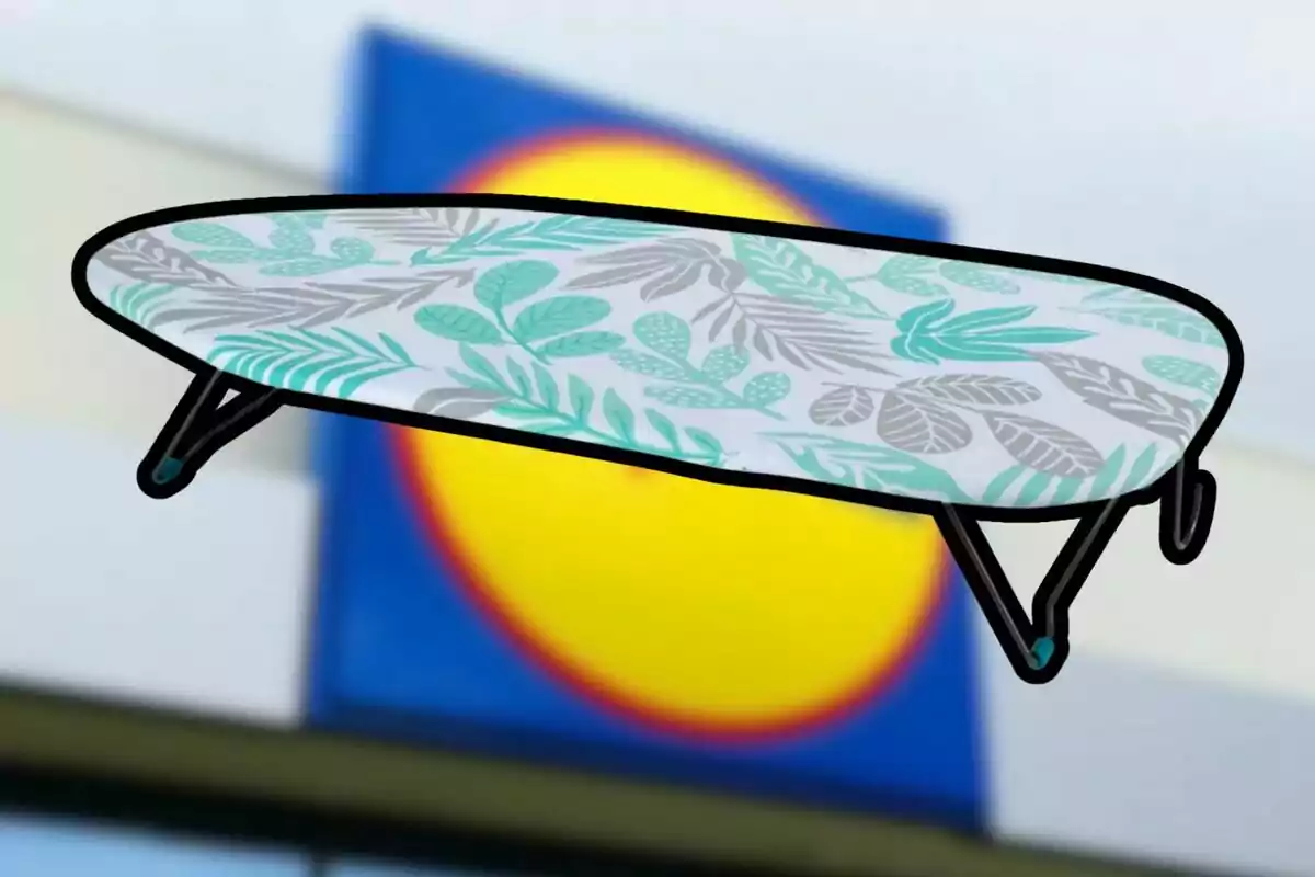 Folding table with a design of green and gray leaves against a blurred background of a yellow and blue sign Folding table with a design of green and gray leaves against a blurred background of a yellow and blue sign