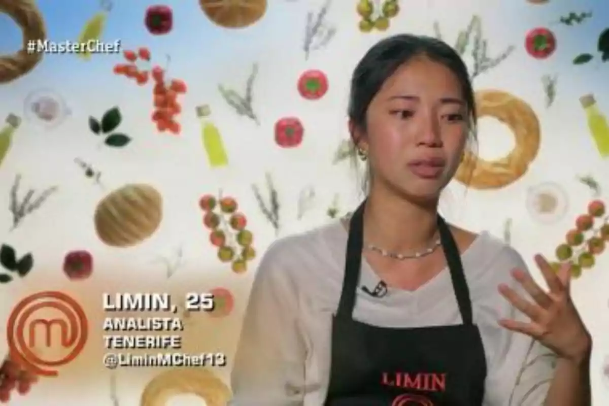 Limin amb davantal negre apareix en un programa de cuina, amb un fons decorat amb imatges d'ingredients com tomàquets, pans i ampolles d'oli a MasterChef. Limin amb davantal negre apareix en un programa de cuina, amb un fons decorat amb imatges d'ingredients com tomàquets, pans i ampolles d'oli a MasterChef.