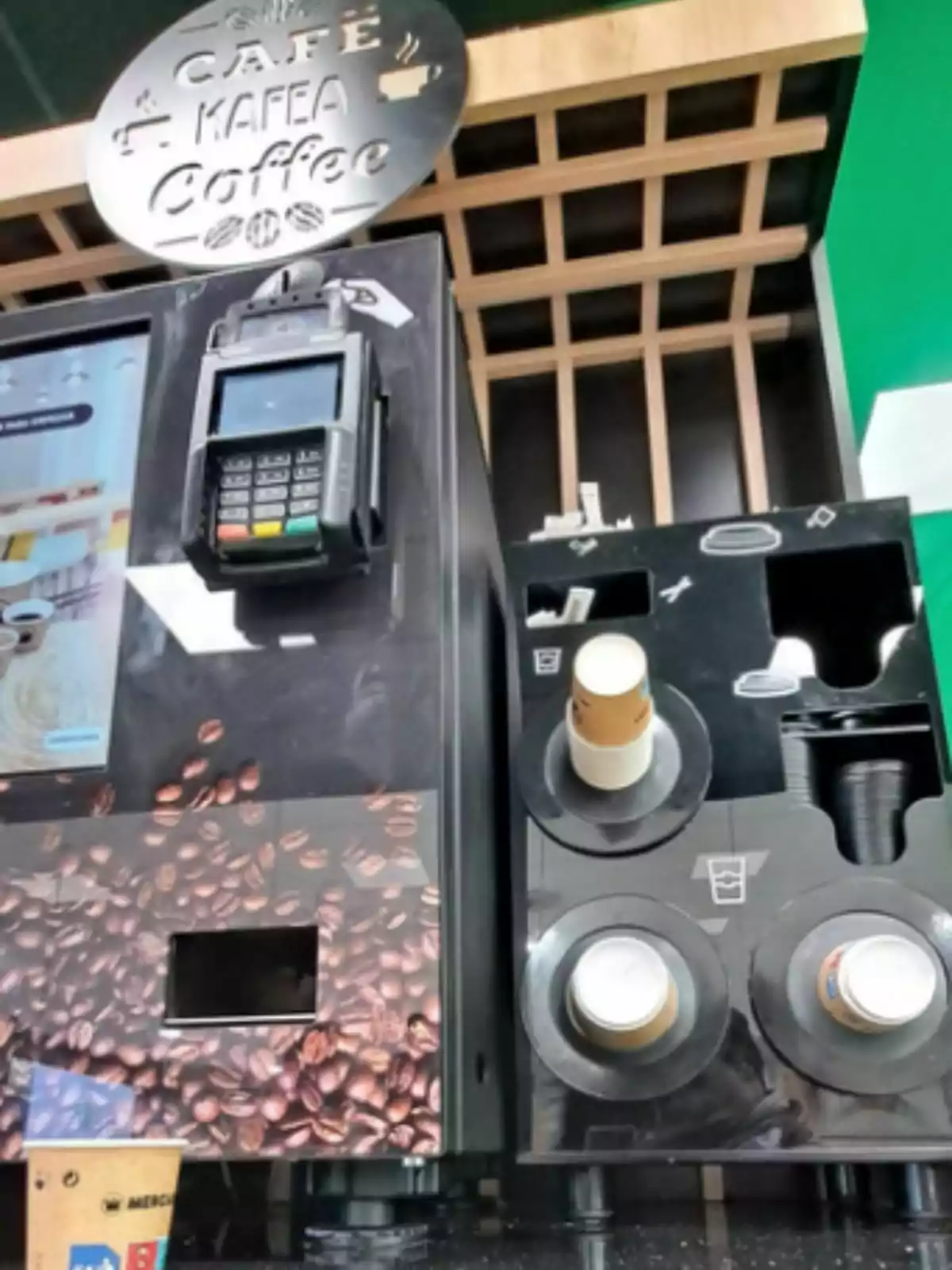 Mercadona coffee vending machine with payment terminal and cup dispenser.