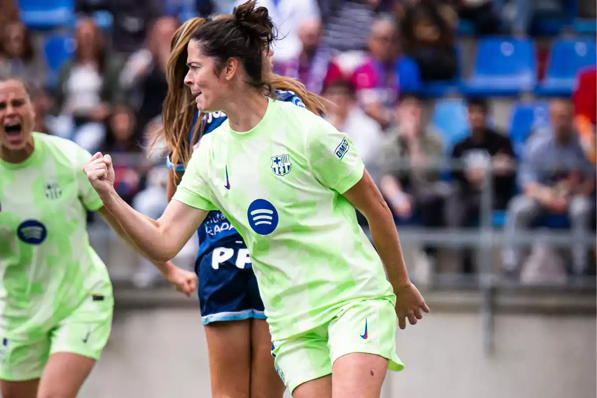 Soccer player celebrating a goal in a match wearing a light green uniform. Soccer player celebrating a goal in a match wearing a light green uniform.