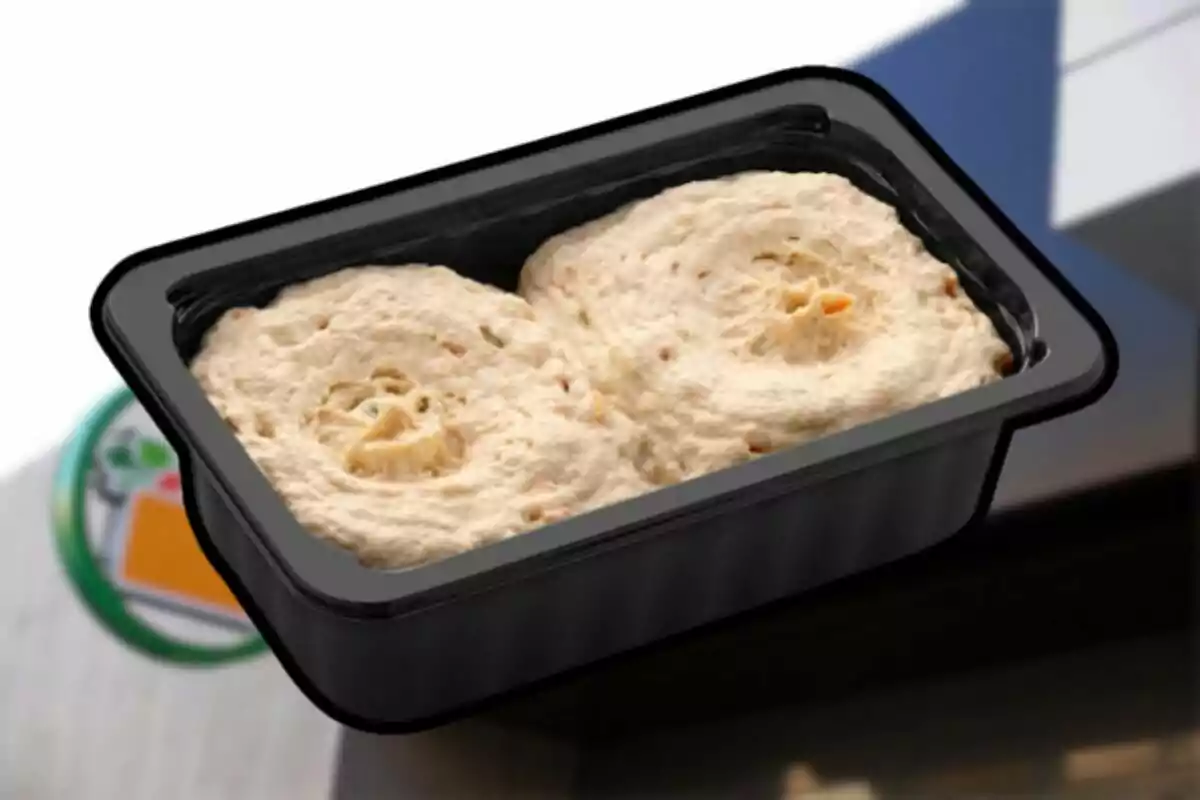 A black container with two portions of raw dough inside. A black container with two portions of raw dough inside.