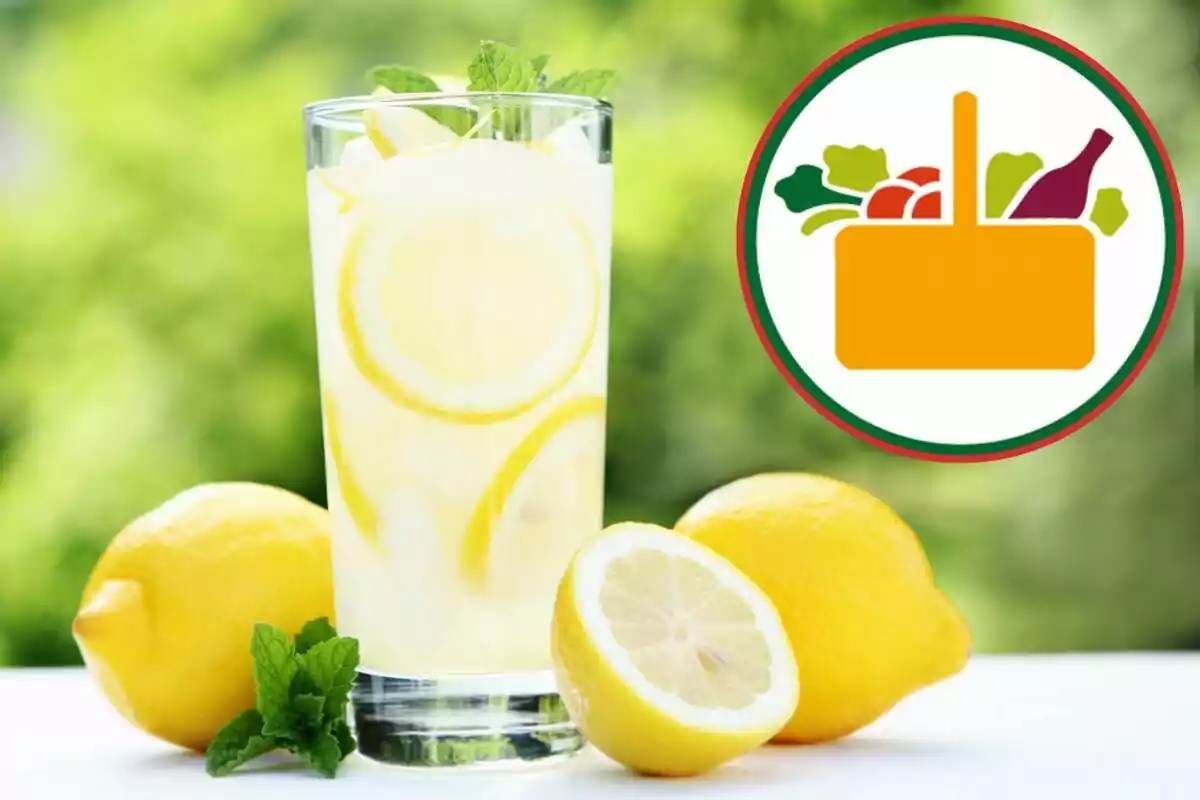 Glass of lemonade with lemon slices and mint leaves next to fresh lemons and a food basket logo in the background Glass of lemonade with lemon slices and mint leaves next to fresh lemons and a food basket logo in the background