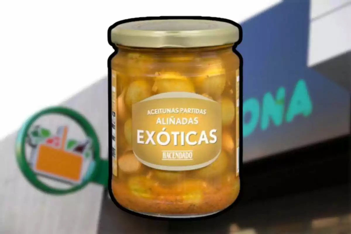 Pot de olives trencades amanides exòtiques de la marca Hacendado davant d’un cartell desenfocat de supermercat Mercadona Pot de olives trencades amanides exòtiques de la marca Hacendado davant d’un cartell desenfocat de supermercat Mercadona