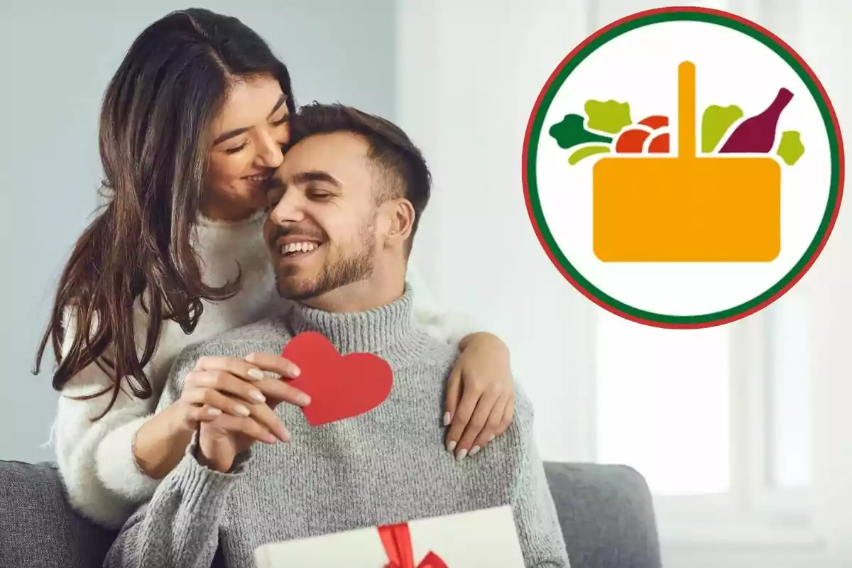 A smiling couple embraces while holding a red paper heart and a gift wrapped with a red ribbon; to the right, there is a logo of a food basket.