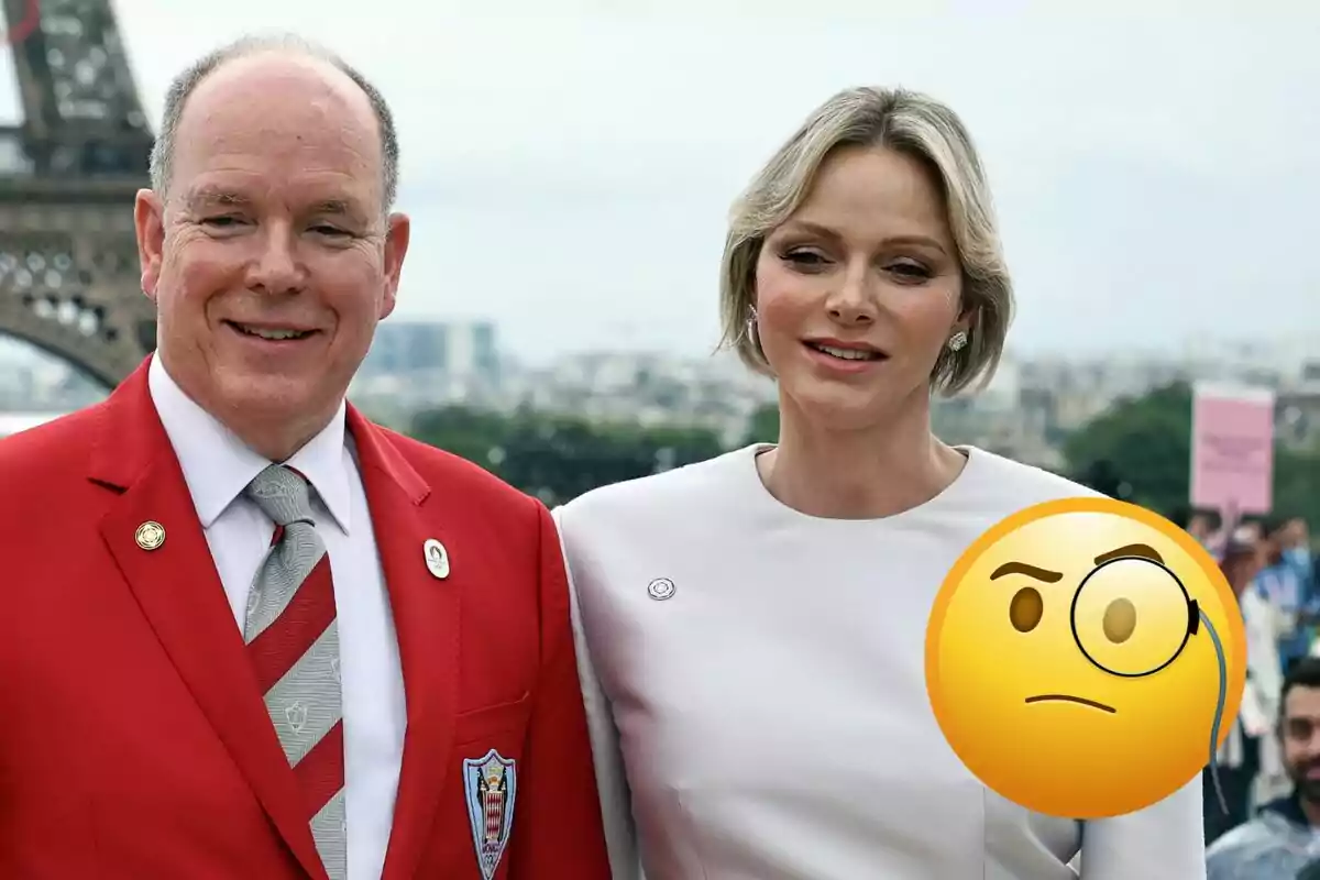 Albert of Monaco and Charlene pose in front of the Eiffel Tower, one of them wearing a red suit and the other a white dress, with a monocle emoji superimposed.