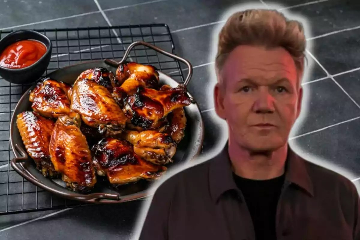 A plate of roasted chicken wings with a container of red sauce on the side and Gordon Ramsay standing in front.