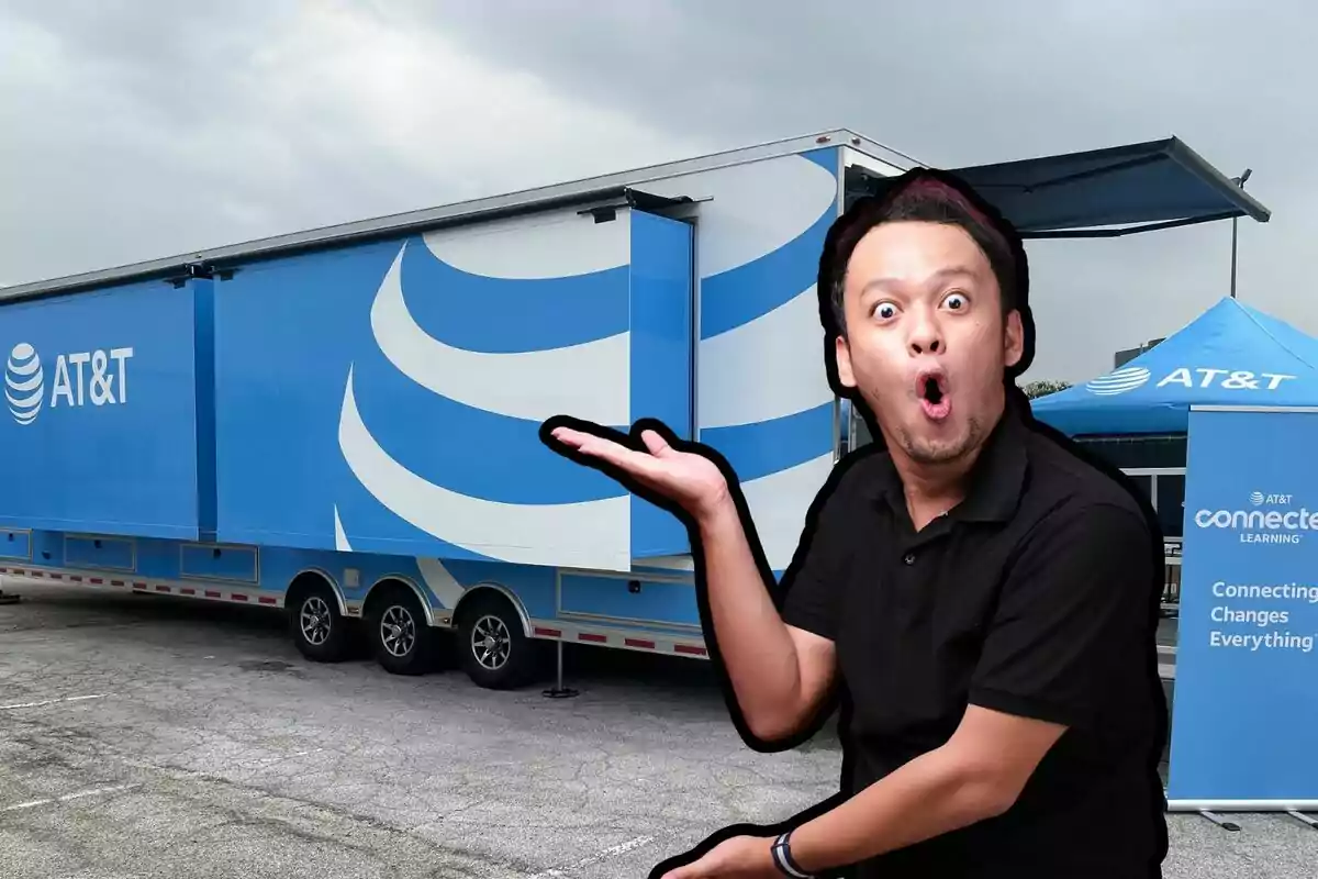 A man with a surprised expression is in front of a blue AT&T truck and a tent of the same color.