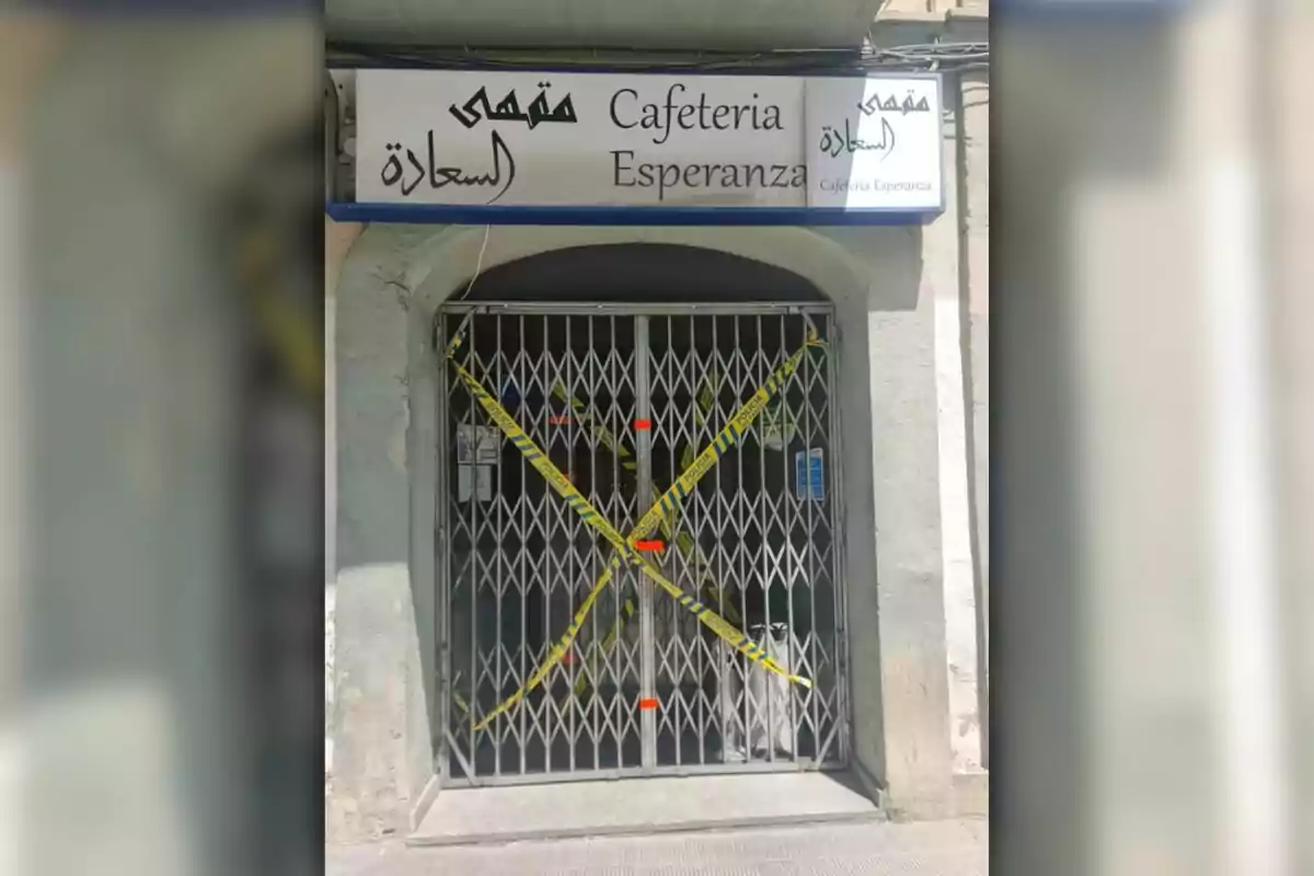 The image shows the entrance of a café called The image shows the entrance of a café called