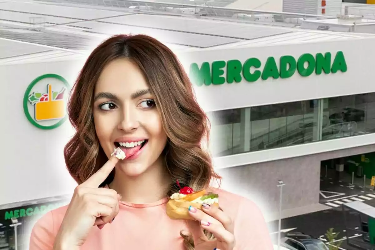 Una mujer sonriente disfruta de un pastel frente a un supermercado Mercadona.
