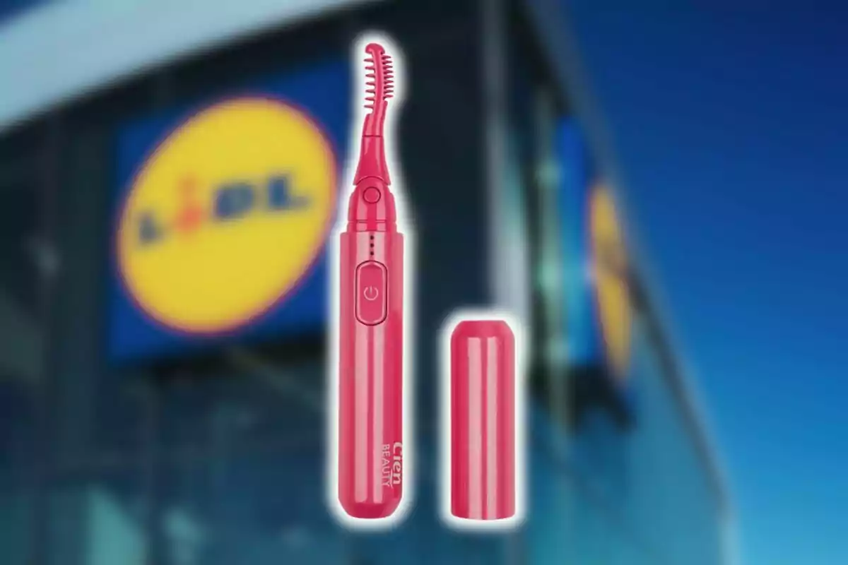 Pink electric eyelash curler from Lidl with a cap next to the facade of a Lidl store blurred in the background. Pink electric eyelash curler from Lidl with a cap next to the facade of a Lidl store blurred in the background.