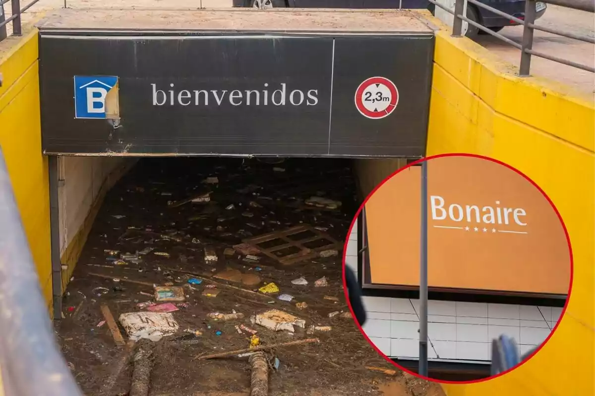 Entrada d'un estacionament subterrani inundat amb runes i un cartell que indica una alçada màxima de 2,3 metres; en un requadre es mostra un rètol del centre comercial Bonaire.