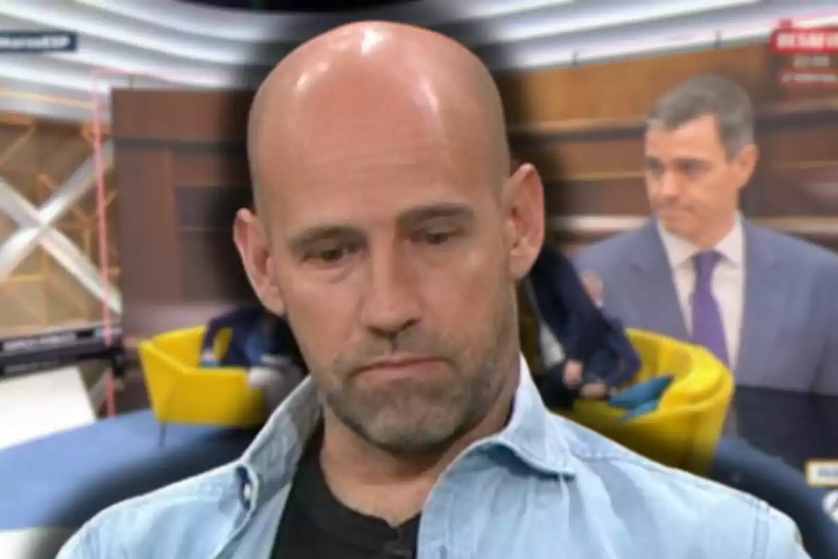 Gonzalo Miró con expresión seria en primer plano con un fondo borroso que muestra un estudio de televisión y una figura masculina en traje.