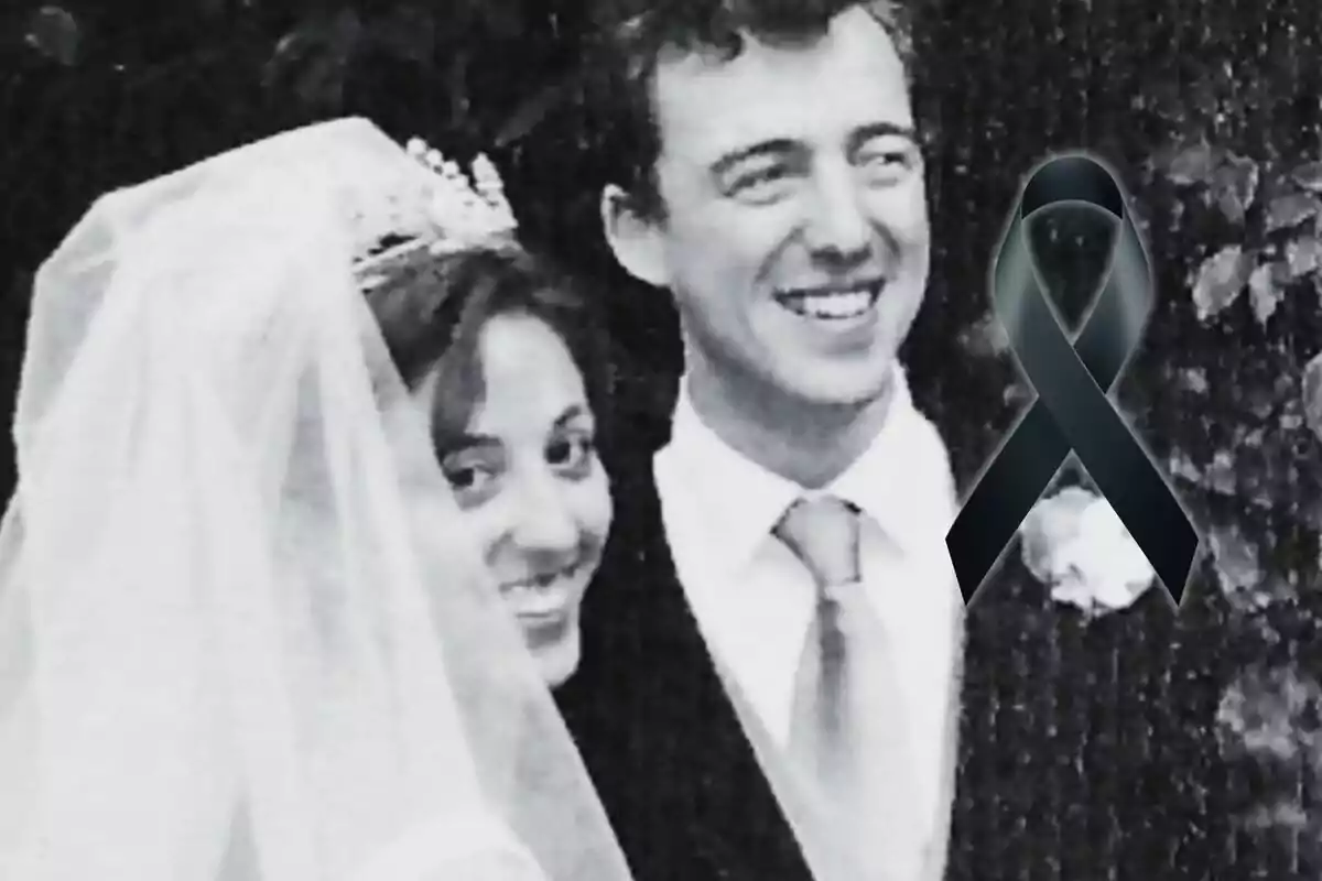 A smiling couple at their wedding with a black ribbon overlaid on the image.