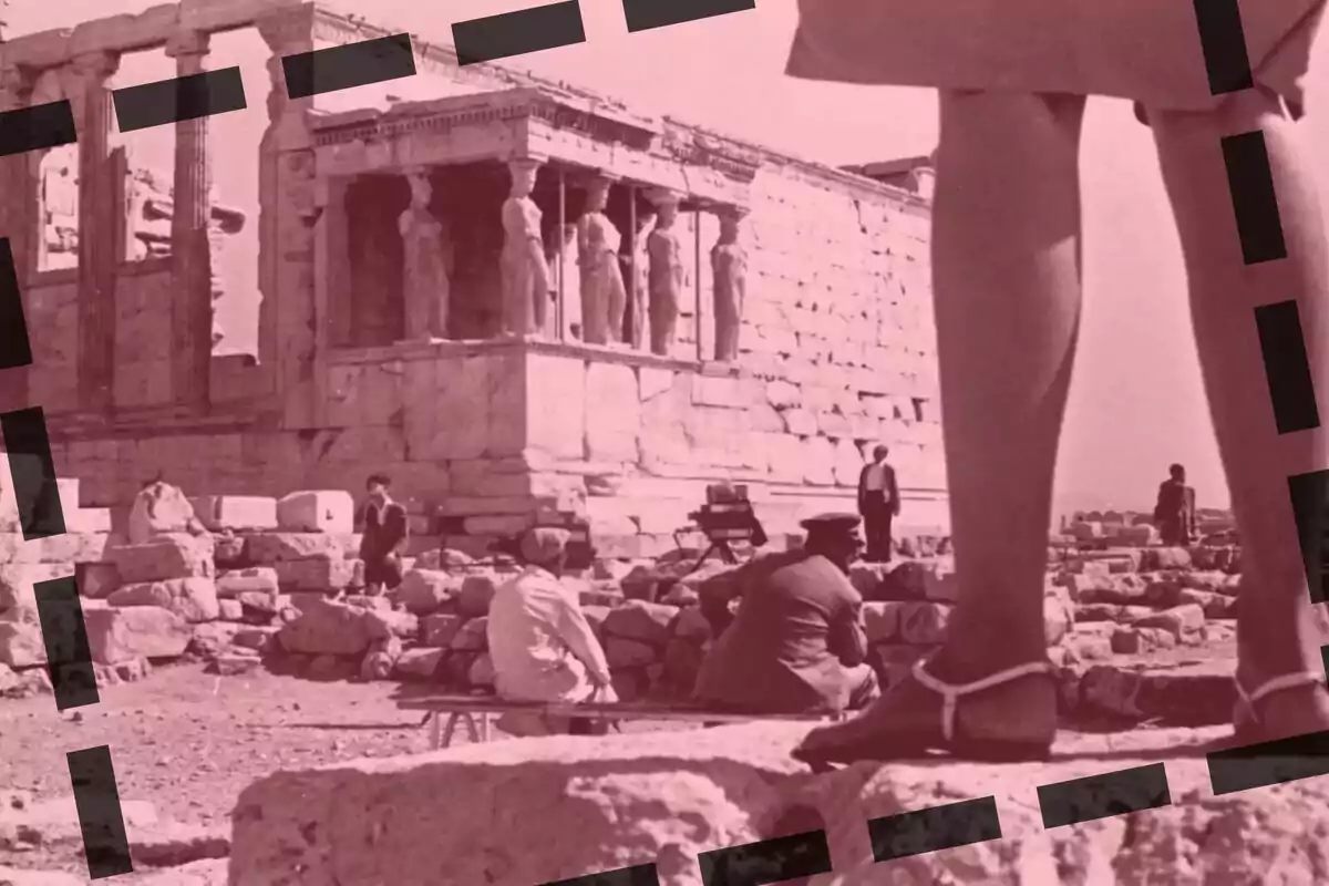 Una imatge en tons rosats mostra una escena en un lloc arqueològic amb diverses persones, destacant una estructura antiga amb columnes i estàtues, mentre que en primer pla es veuen les cames d'una persona amb sandàlies.