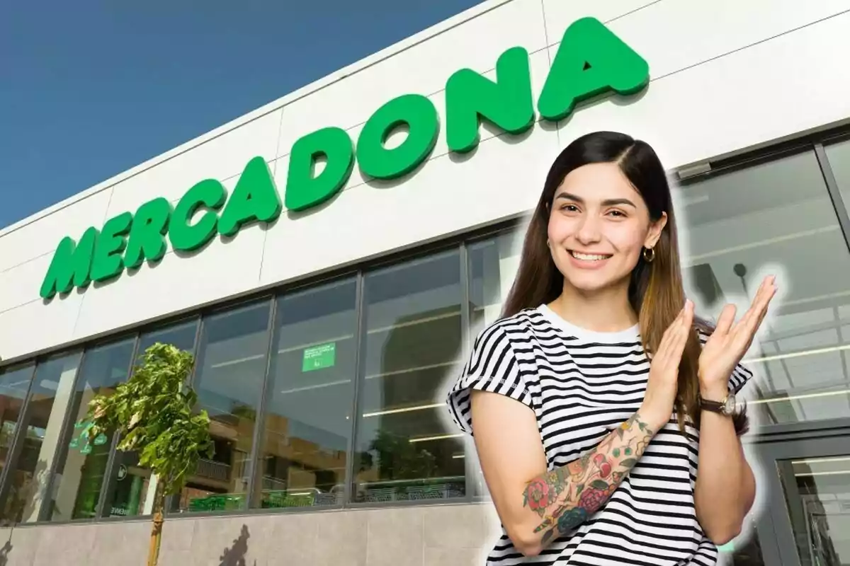 A smiling woman with tattoos on her arm in front of a Mercadona supermarket.