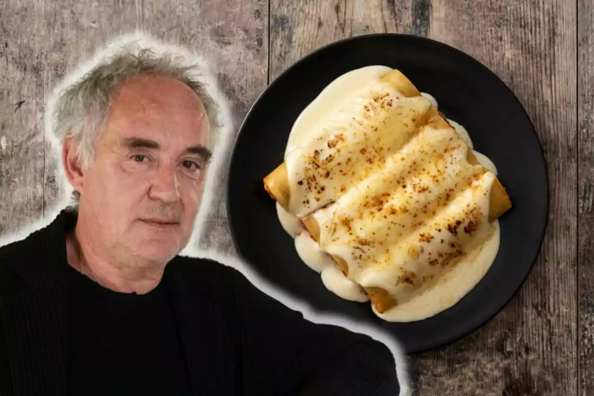 Ferran Adrià de cabell canós al costat d'un plat de canelons amb salsa blanca sobre una taula de fusta.