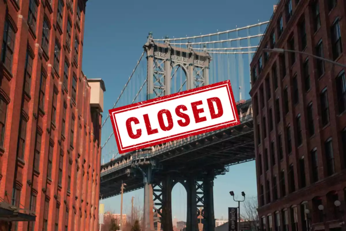 View of a bridge between brick buildings with a sign that says "CLOSED" in the center.