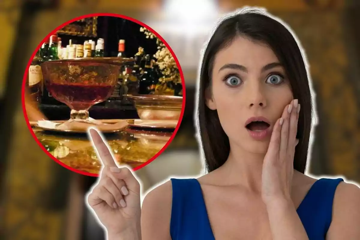 A woman with a surprised expression points to a drink in a large glass at a bar.