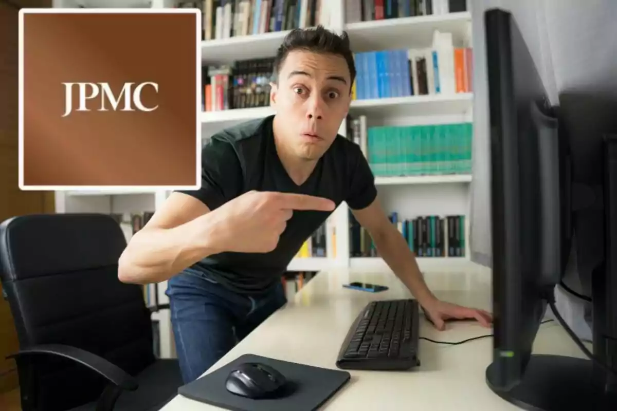 A surprised man points to a computer screen in an office with bookshelves full of books, while a brown logo with the letters JPMC appears in the top left corner. A surprised man points to a computer screen in an office with bookshelves full of books, while a brown logo with the letters JPMC appears in the top left corner.