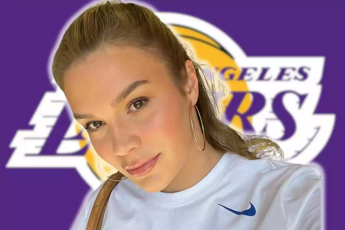 Anamaria Goltes in a white t-jersey and large earrings in front of a background with the Lakers logo.