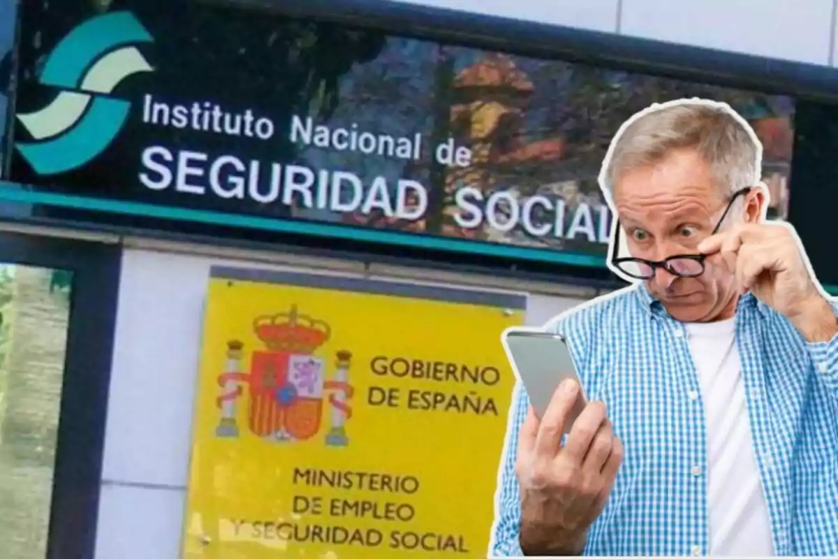 Un home gran amb ulleres mira sorprès el telèfon mòbil davant d'un edifici de l'Institut Nacional de Seguretat Social a Espanya.