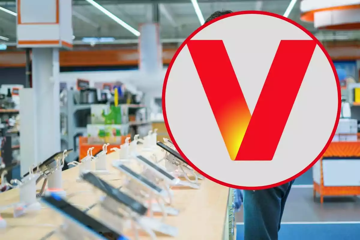 An electronics store with a row of mobile phones on display and a large red logo in the center of the image. An electronics store with a row of mobile phones on display and a large red logo in the center of the image.