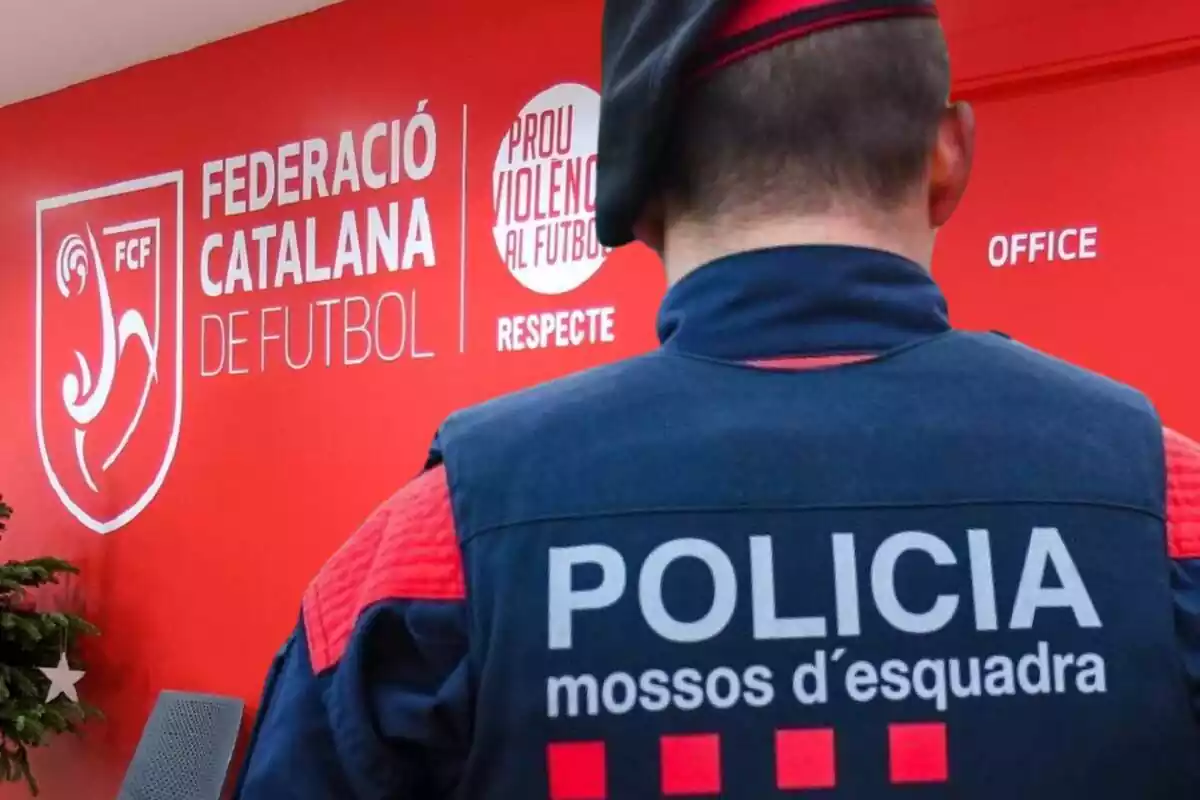 Imatge d'un Mosso d'Esquadra d'esquena a les oficines de la Federació Catalana de Futbol