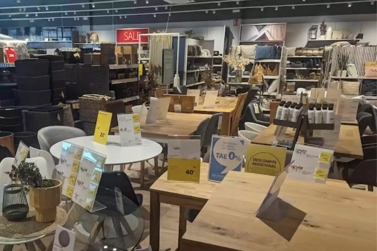 A furniture store with tables and chairs on display, discount signs, and decorative products on shelves.