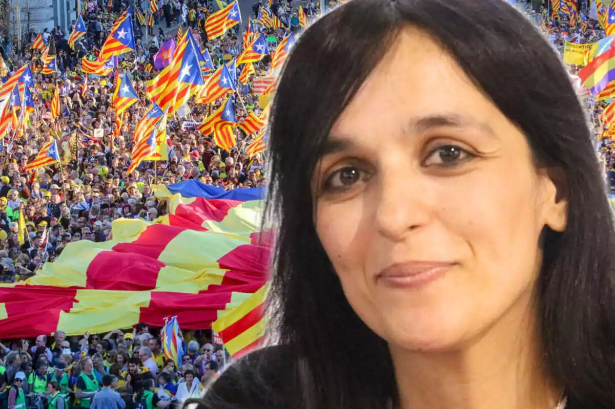 Primer pla de Sílvia Orriols amb una imatge de fons d'una manifestació independentista