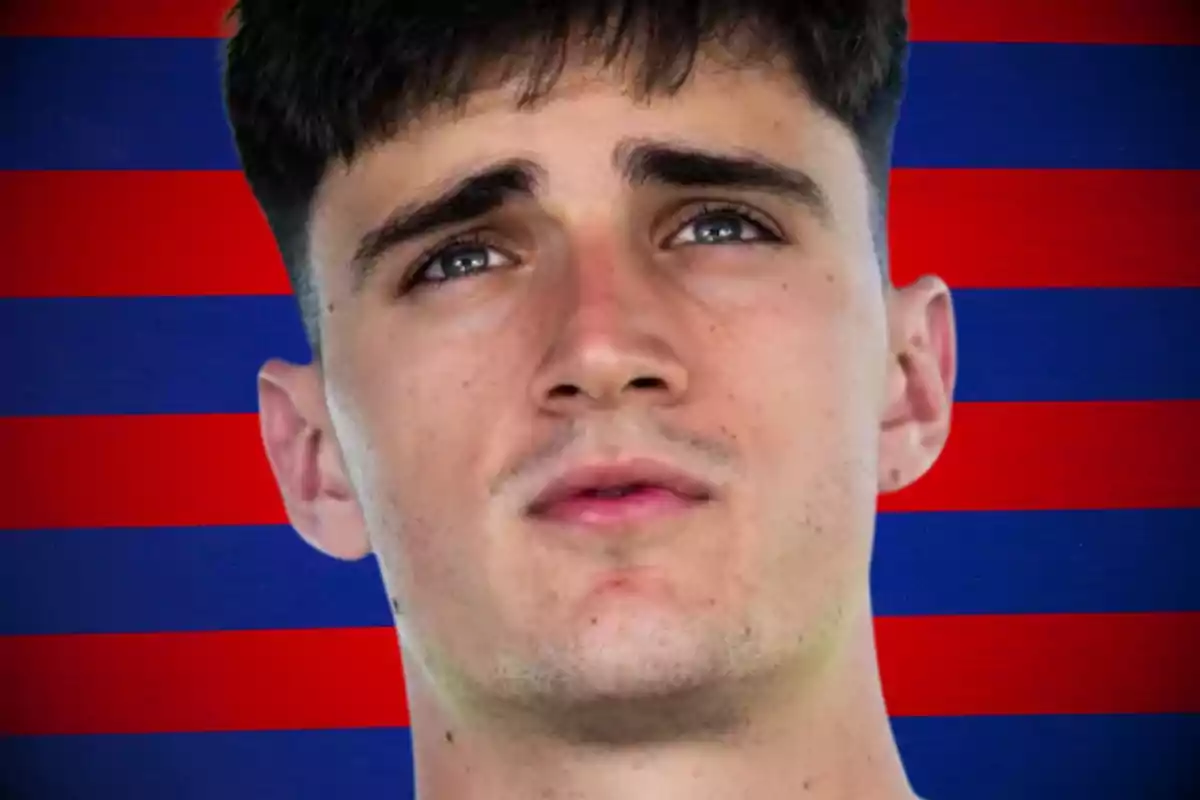 A young man with a serious expression in front of a red and blue striped background.