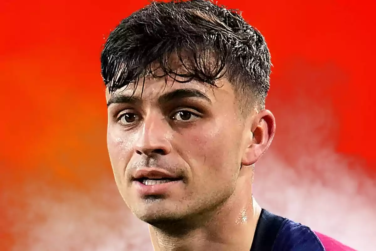 Young man with short dark hair, sweat on his face, and a blurred red background