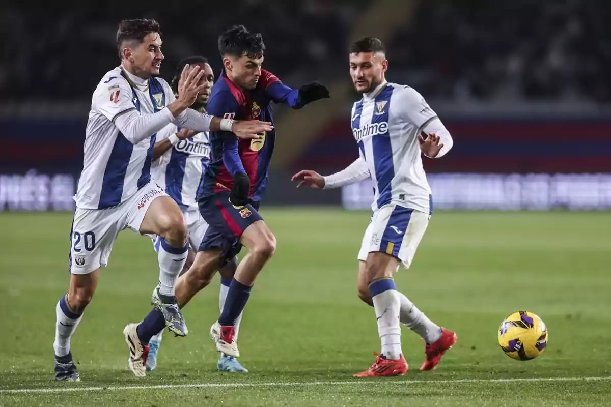 Jugadors de futbol competeixen per la pilota en un partit. Jugadors de futbol competeixen per la pilota en un partit.