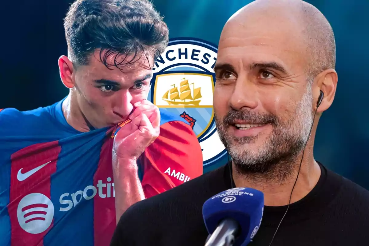 Un jugador de futbol fa un petó a l'escut de la samarreta mentre un home somriu amb un micròfon a prop, amb el logotip del Manchester City de fons.