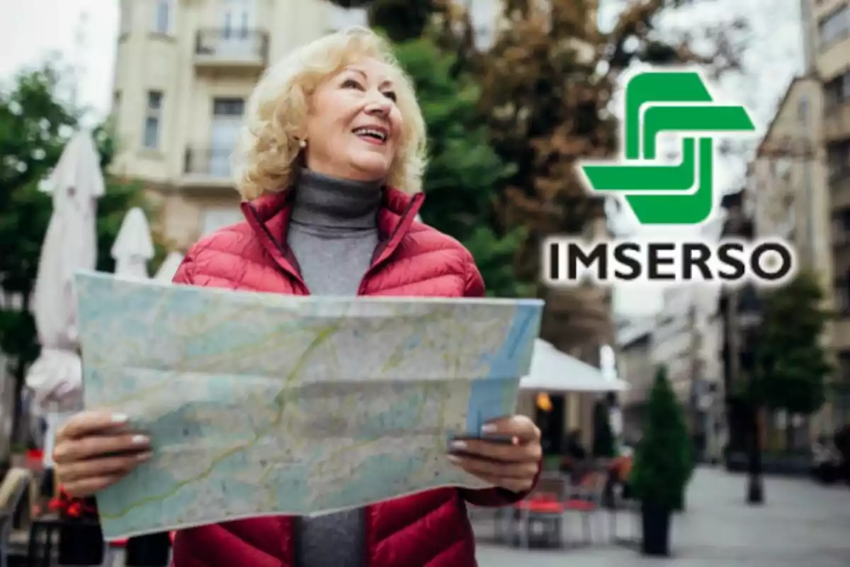 Dona major somrient mentre sosté un mapa, amb el logo de IMSERSO al fons.