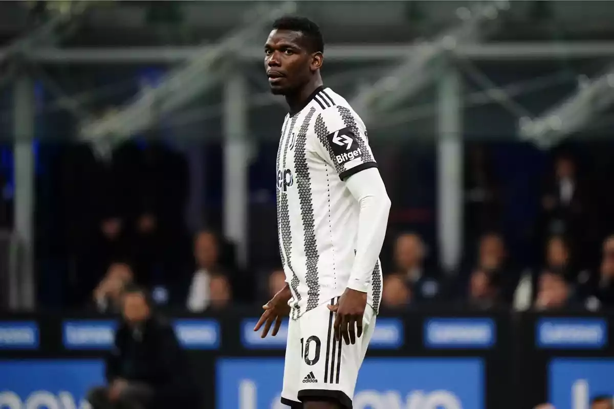 A soccer player in a black and white uniform on the field during a match. A soccer player in a black and white uniform on the field during a match.