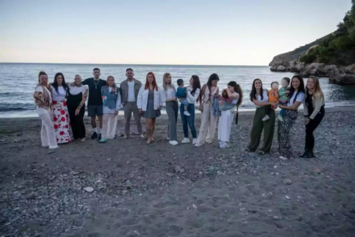 A group of people posing on the beach at sunset with the sea in the background. A group of people posing on the beach at sunset with the sea in the background.