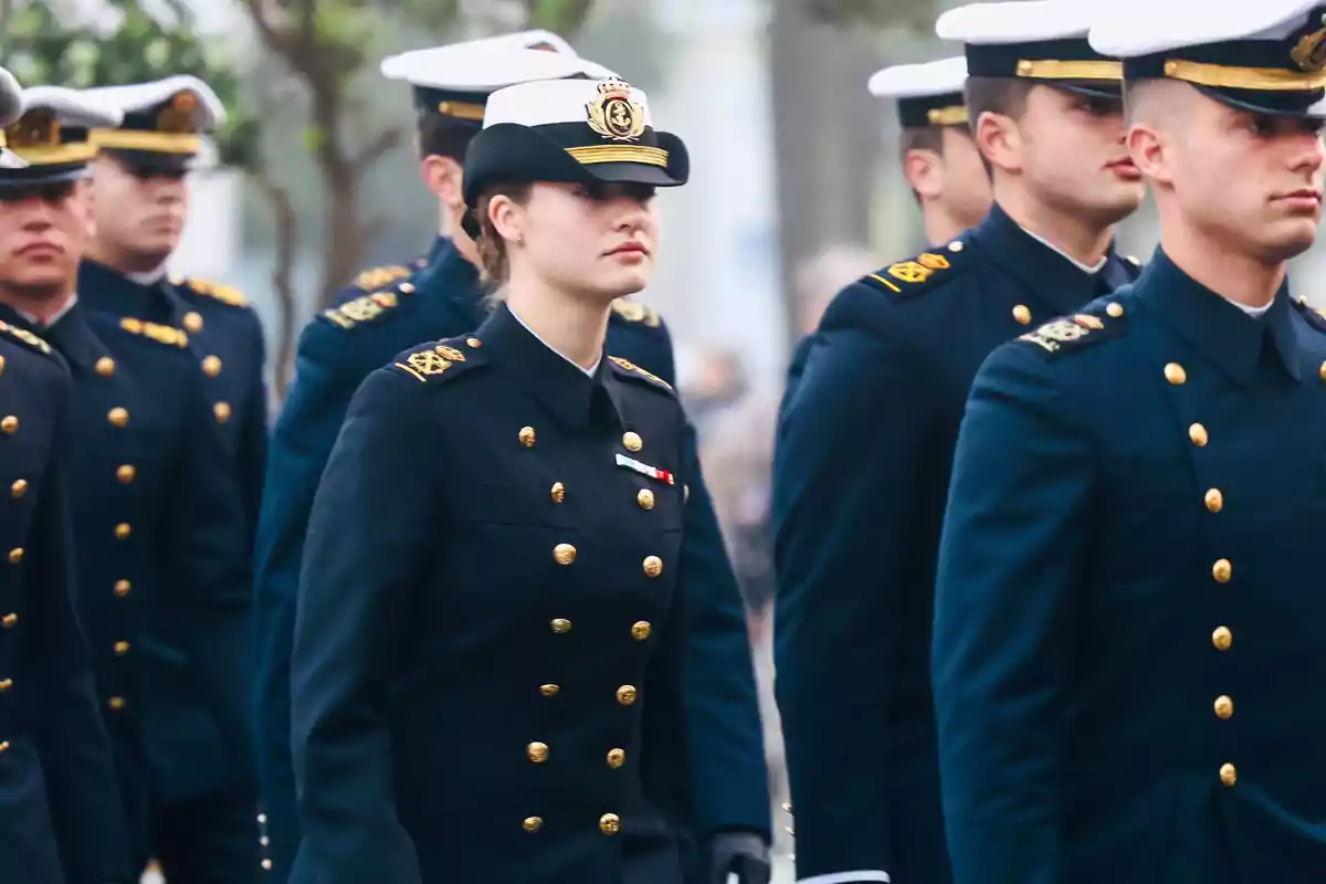 Princess Leonor in naval uniform marching in formation.