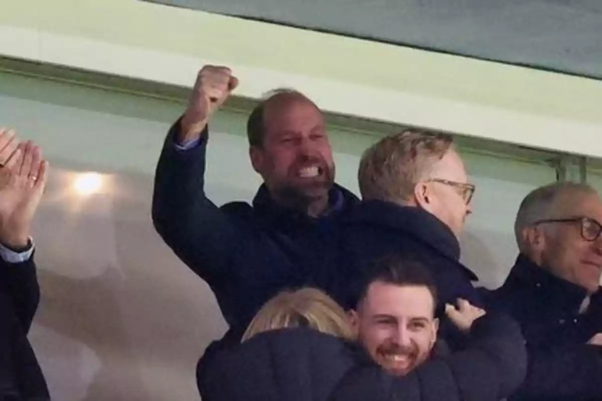 A group of people enthusiastically celebrating at a sporting event.