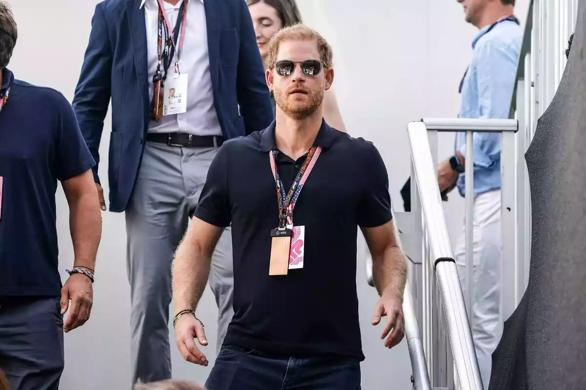 Prince Harry wearing sunglasses walking down stairs