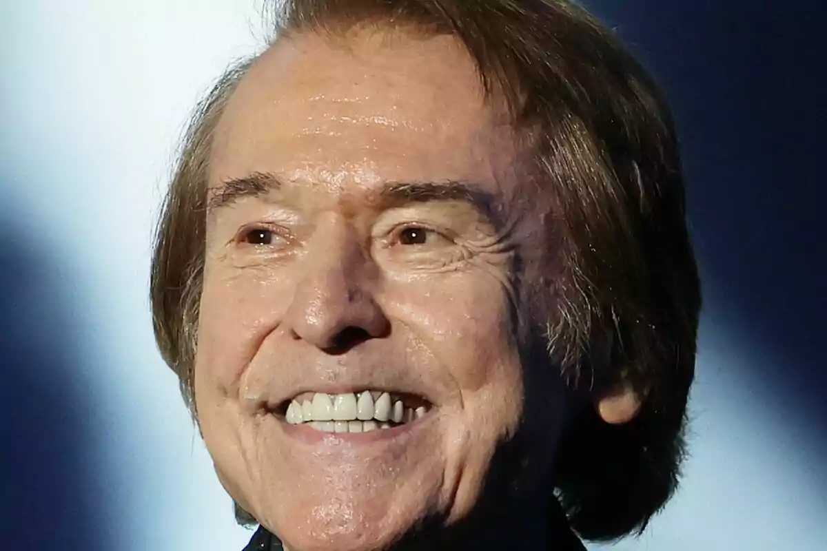 Close-up of Raphael smiling against a blurred background. Close-up of Raphael smiling against a blurred background.
