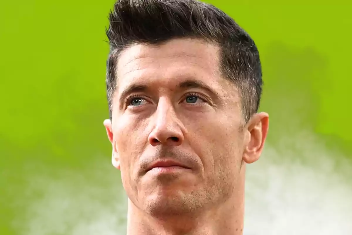 Close-up of a man with short dark hair and a serious expression against a blurred green background