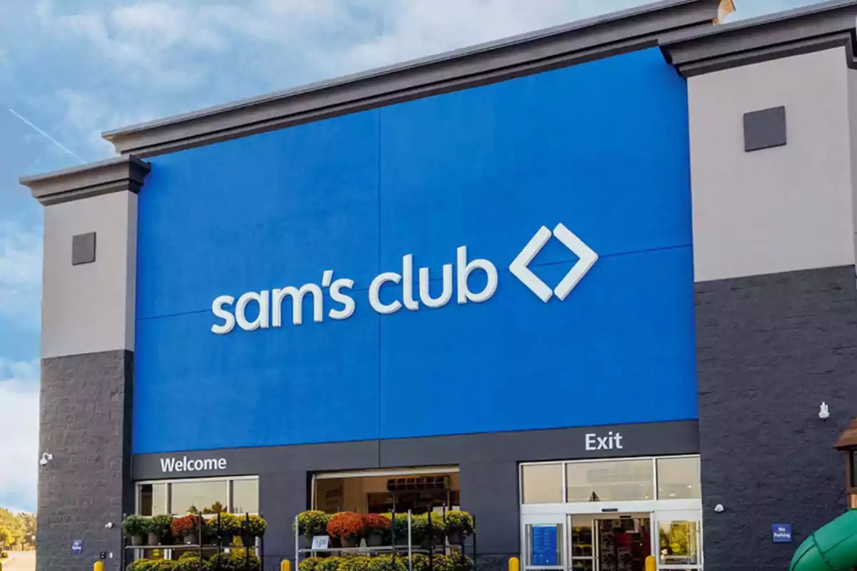 Storefront with a large blue sign that says "Sam's Club" and two entrance and exit doors at the bottom.