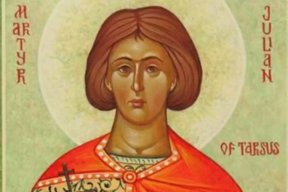 Una imatge d'una icona religiosa que representa una figura amb cabell castany i una túnica vermella, amb un halo daurat darrere del seu cap i text als marges. Una imatge d'una icona religiosa que representa una figura amb cabell castany i una túnica vermella, amb un halo daurat darrere del seu cap i text als marges.