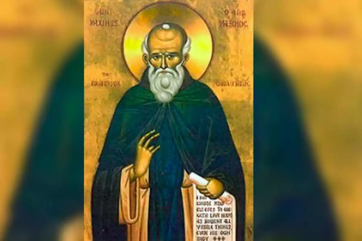 Una imatge d'un icona religiós que mostra un home amb barba blanca i halo daurat, vestit amb túnica fosca i sostenint un pergamí.