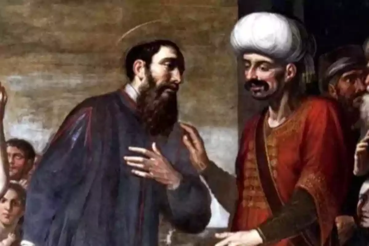 Pintura antiga que mostra dos homes conversant, un amb barba i túnica fosca i l’altre amb turbant blanc i vestimenta vermella.
