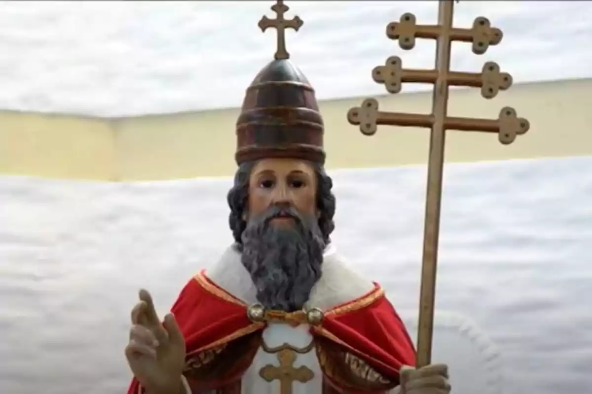 Escultura religiosa d’un home amb barba i vestimenta papal sostenint un bàcul amb diverses creus