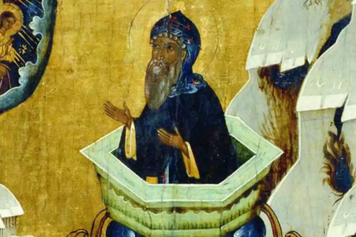 Una pintura religiosa mostra un home amb vestimenta fosca i barba dins d'una estructura cilíndrica amb les mans aixecades en actitud d'oració mentre mira cap a una figura celestial al cel. Una pintura religiosa mostra un home amb vestimenta fosca i barba dins d'una estructura cilíndrica amb les mans aixecades en actitud d'oració mentre mira cap a una figura celestial al cel.