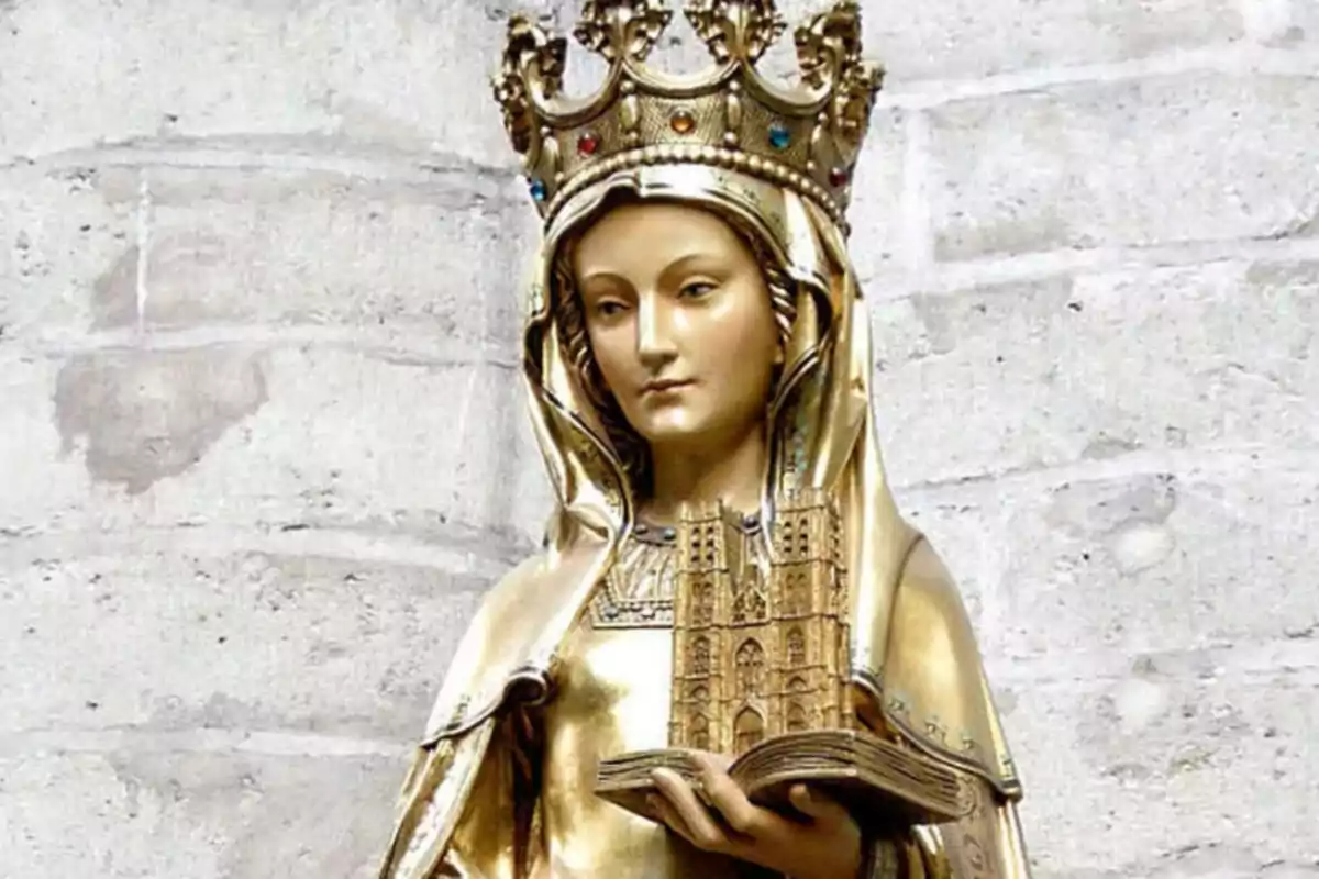 Estatua dorada de una figura femenina con corona sosteniendo una maqueta de una catedral.