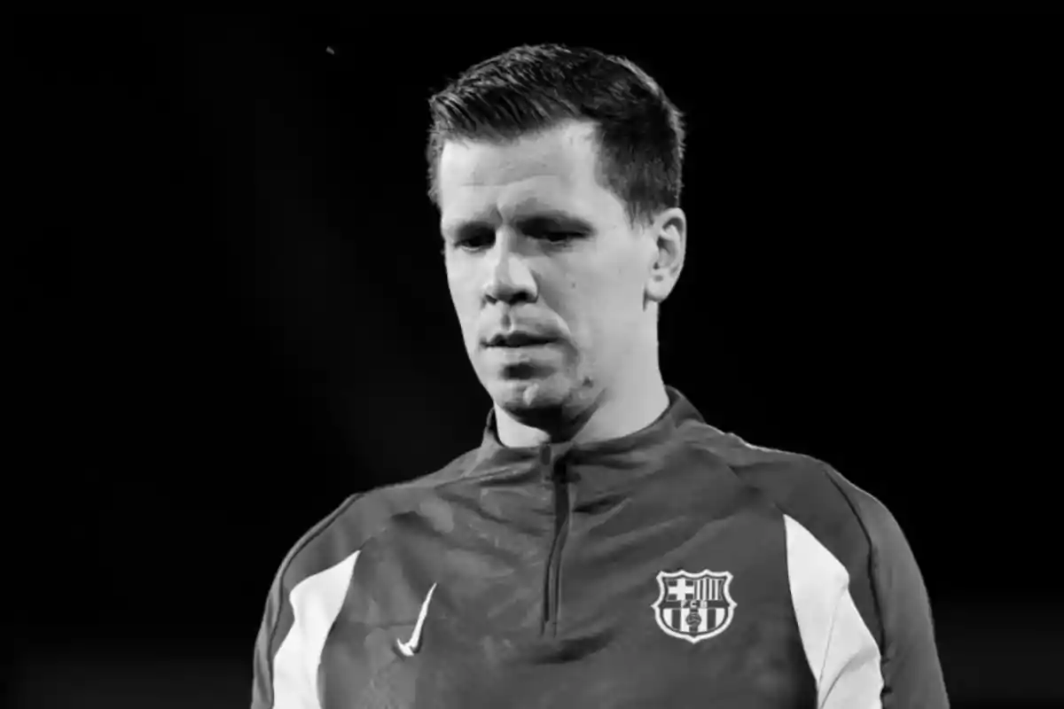 A man wearing a sports jacket with a black and white football team logo.