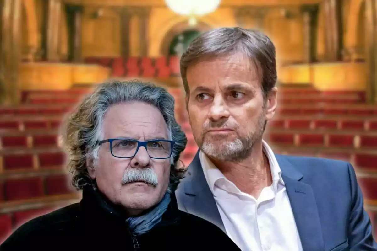 Two middle-aged men with serious expressions in a setting that appears to be an auditorium or theater with red seats.